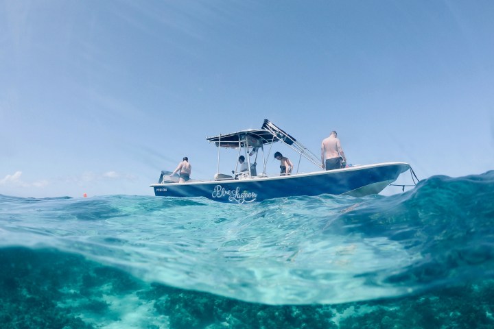 a man riding on the back of a boat in a body of water