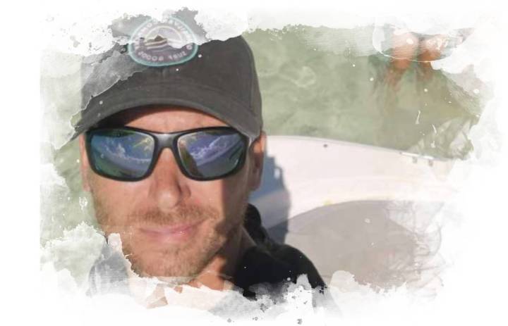 captmax a man wearing a hat and glasses
